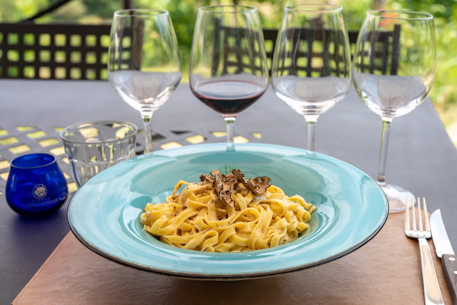 Fresh tagliatelle with shaved truffle and a glass of red wine